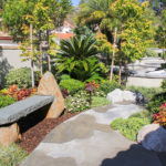 Pathway to pool with modern stone bench