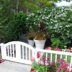 Cottage Landscape with Bright Flowers and White Gate